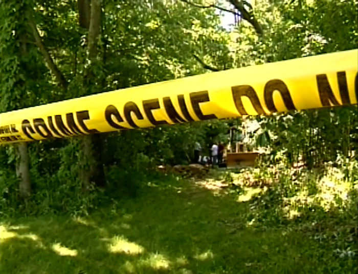 Crime scene tape at a wooded farm area where the 10th body was found on suspected serial killer&rsquo;s property.