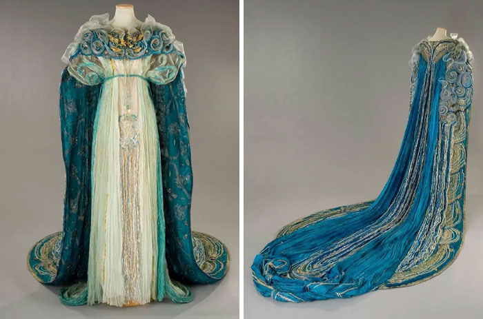 Historical fashion gown with intricate blue and white designs, showcasing centuries of fashion evolution in detailed textile art.