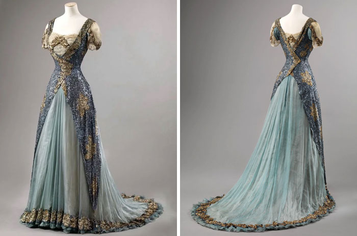 Elegant vintage evening gown with intricate embroidery and flowing train, showcasing centuries of fashion evolution.