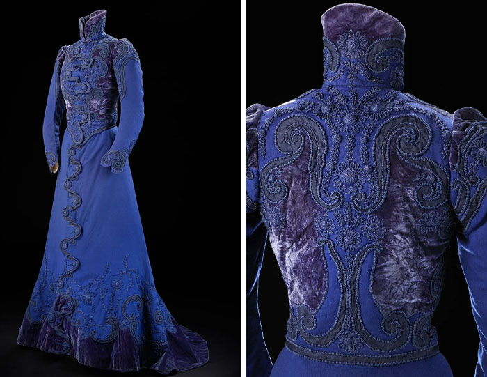 Victorian-era blue embroidered dress with intricate velvet details showcasing centuries of fashion history in a single garment.