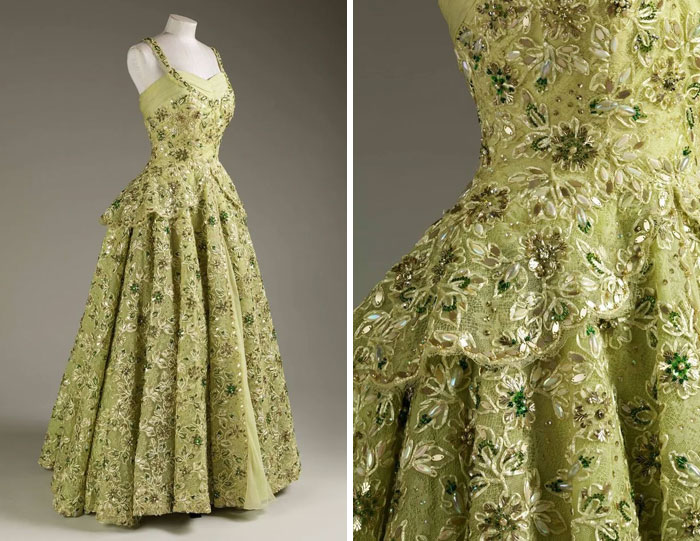 Green vintage evening gown with floral embroidery and beadwork, showcasing centuries of fashion history in intricate detail.