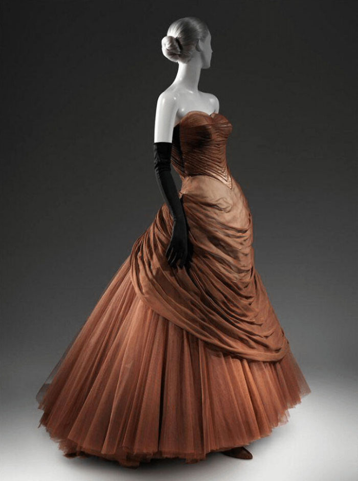 Vintage brown evening gown with ruched bodice and full tulle skirt showcased in a centuries of fashion collection.