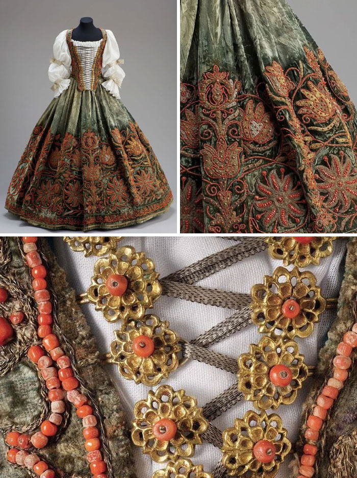 Historic fashion dress with intricate embroidery, ornate floral patterns, and detailed vintage embellishments on fabric and bodice.