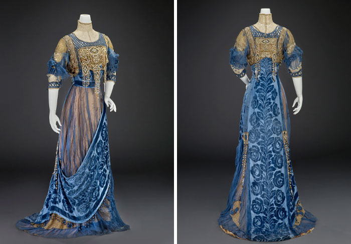 Blue and gold vintage gown with intricate embroidery and velvet fabric, showcasing centuries of fashion evolution on mannequins.