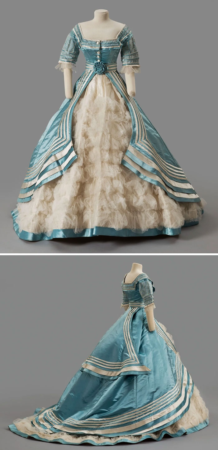 Blue and white historical fashion dress with ruffled skirt and detailed bodice showcased in centuries of fashion collection