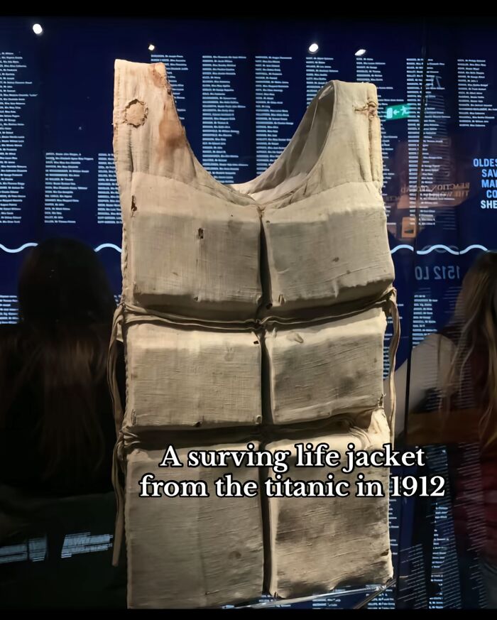Surviving life jacket from the Titanic displayed in a museum, showcasing monumental historical life moments.