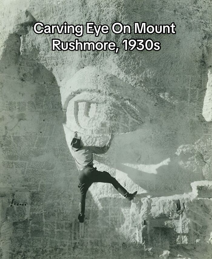 Man carving the eye on Mount Rushmore in the 1930s, a monumental life moment frozen in time in history.