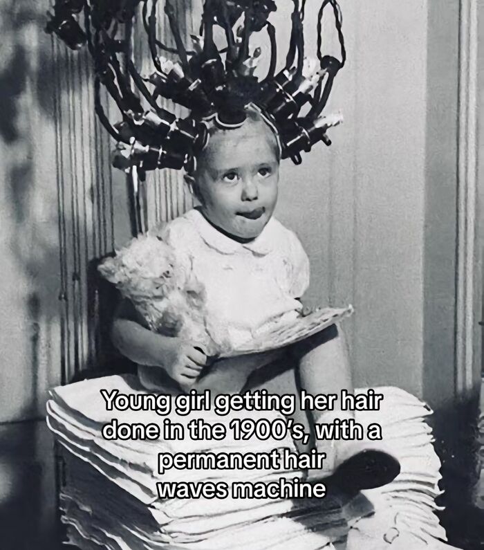 Young girl in the 1900s having her hair done with a permanent waves machine, capturing a monumental life moment frozen in time.