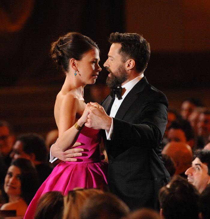 Hugh Jackman and Sutton Foster dancing at an event, showcasing their long history in the entertainment industry.