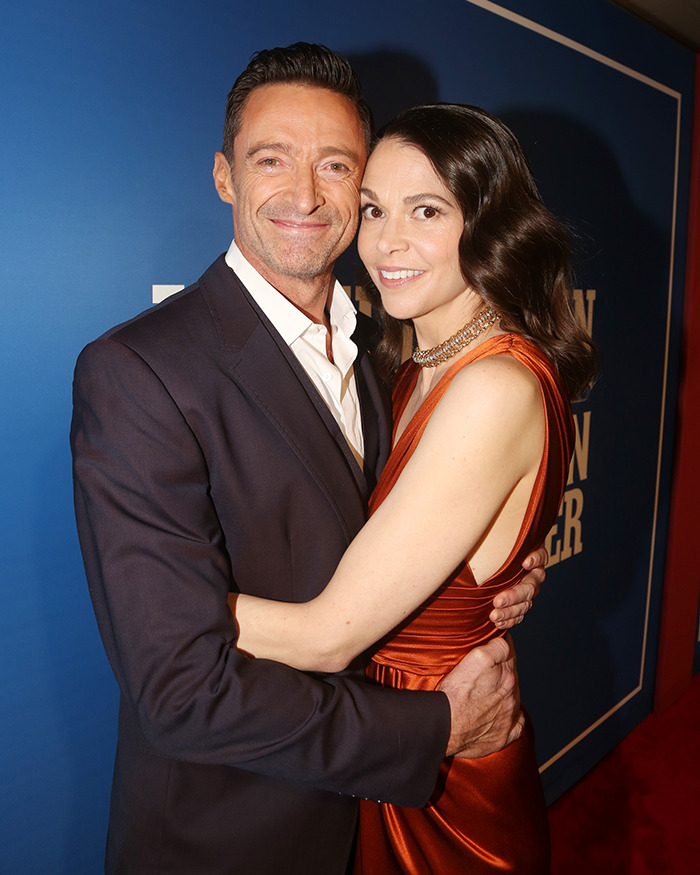 Hugh Jackman and Sutton Foster embracing on the red carpet, posing for photos during a public event. Hugh Jackman and Sutton Foster embracing on the red carpet, posing for photos during a public event.