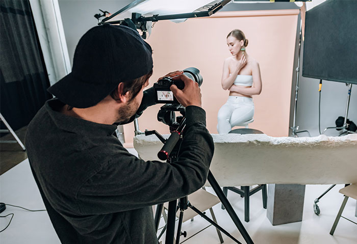 Photographer capturing a woman in a studio, illustrating a spicy photoshoot concept with postpartum weight concerns. Photographer capturing a woman in a studio, illustrating a spicy photoshoot concept with postpartum weight concerns.