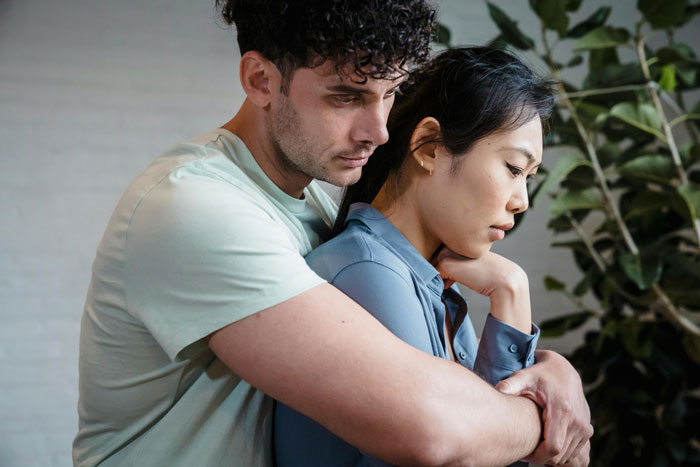 Wife feeling insecure about hubby connecting with mutual friend as they share a tense moment indoors near plants. Wife feeling insecure about hubby connecting with mutual friend as they share a tense moment indoors near plants.