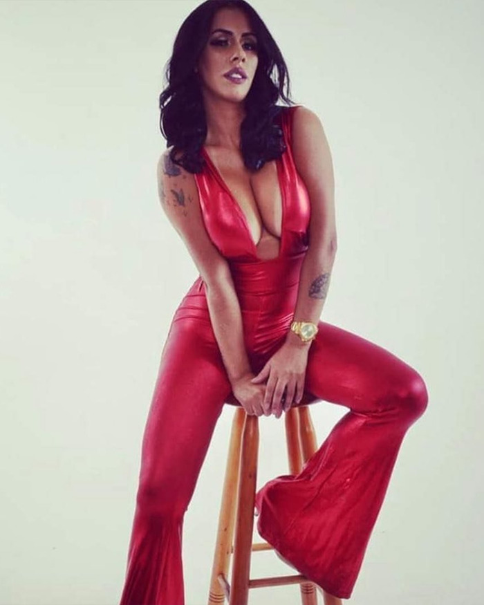 Woman in red jumpsuit sitting on a wooden stool, appearing confident, related to Ozempic injection claims story. Woman in red jumpsuit sitting on a wooden stool, appearing confident, related to Ozempic injection claims story.