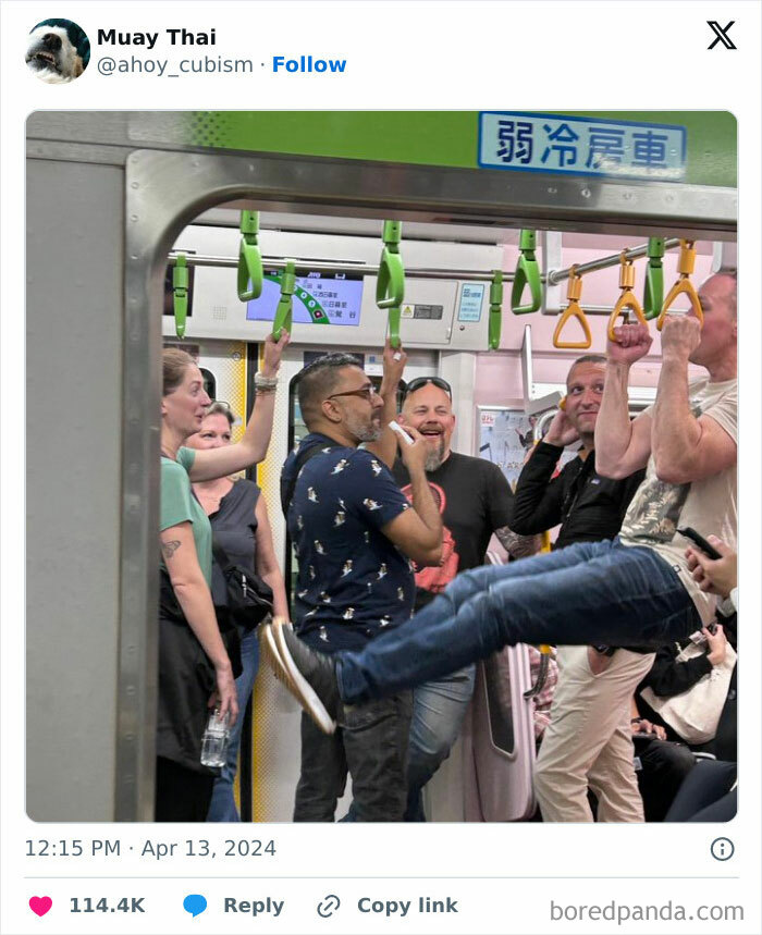 Entitled rude tourists swinging on subway handrails, disrupting other passengers during a crowded train ride.
