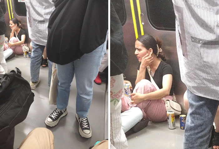Entitled rude tourists sitting on subway floor surrounded by standing passengers in a crowded train car.
