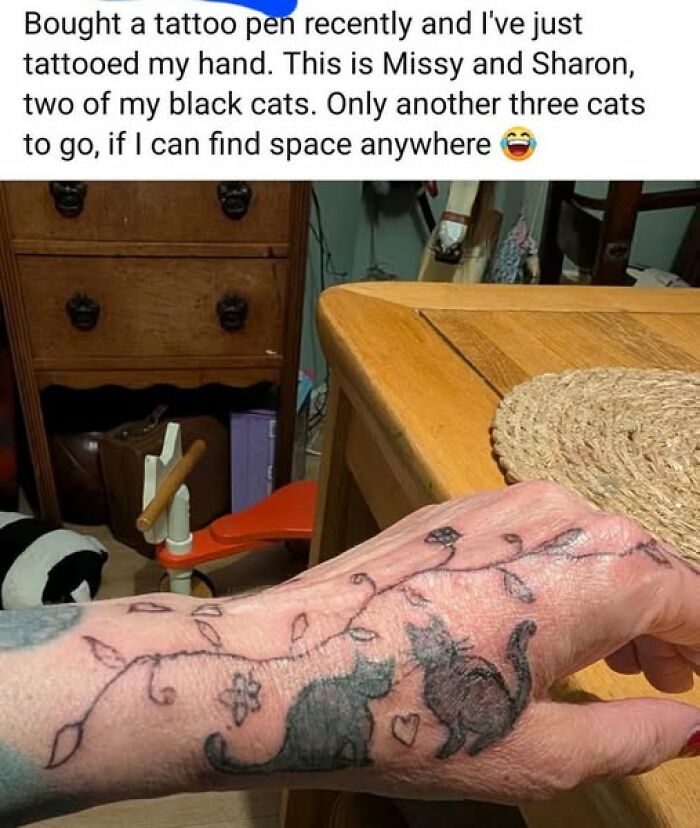 Hand with homemade tattoo of two black cats and vine designs, illustrating a permanent mistake in inked tattoos.