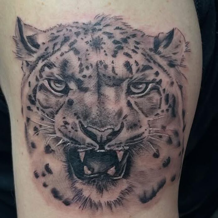 Realistic leopard tattoo on skin showing detailed face and open mouth, part of permanent tattoo mistakes collection.