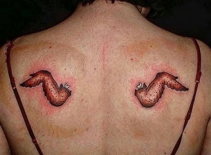 Back tattoos of mismatched chicken wings with redness on skin, showing a permanent mistake inked to look cool.