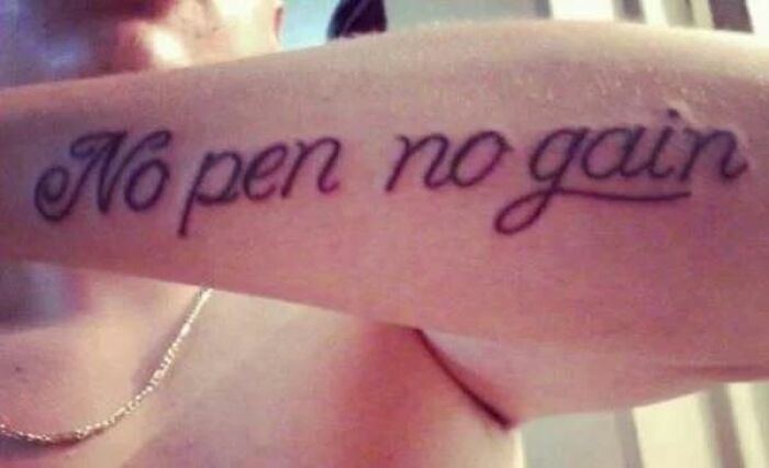 Tattoo with a spelling mistake reading No pen no gain on a person's arm, illustrating permanent tattoo mistakes.