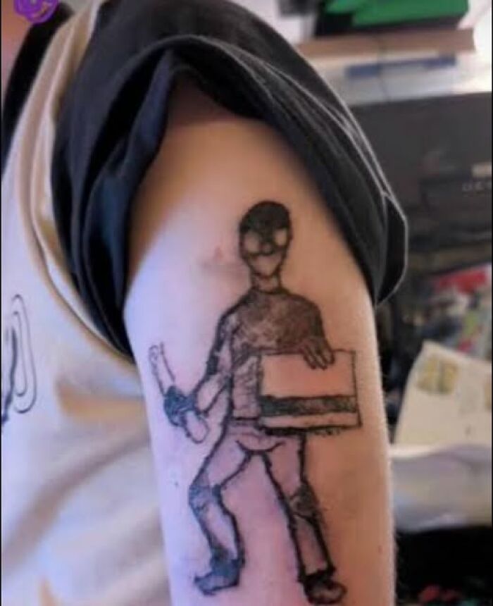 Tattoo of a poorly drawn person holding a box and an object, showcasing a permanent tattoo mistake aiming to look cool.