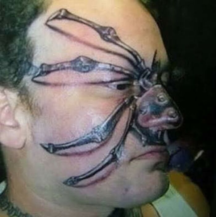 Close-up of a man with a spider tattoo on his face, illustrating one of the permanent mistakes from people who got inked.