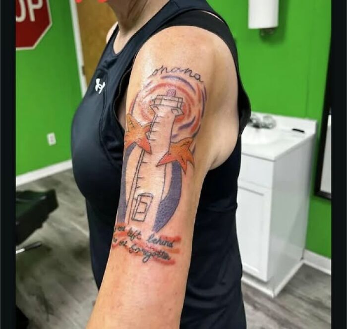 Tattoo with a lighthouse and starfish inked on upper arm, showcasing a permanent mistake in cool tattoo design.