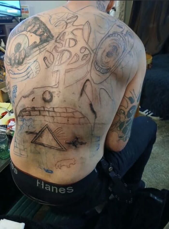 Man showing multiple poorly done tattoos on his back, illustrating permanent mistakes in inked designs.