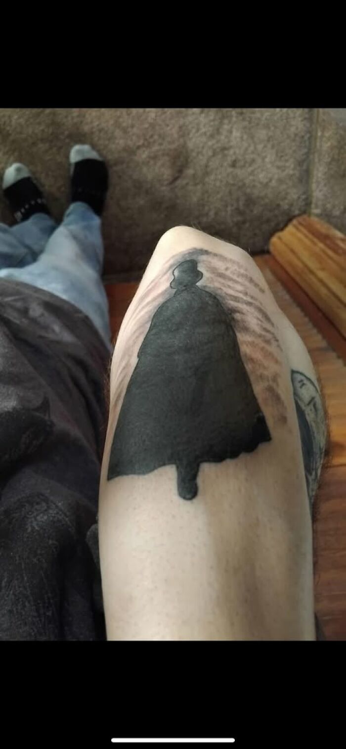 Tattoo of a black silhouette on a leg showing a permanent mistake in cool inked body art.