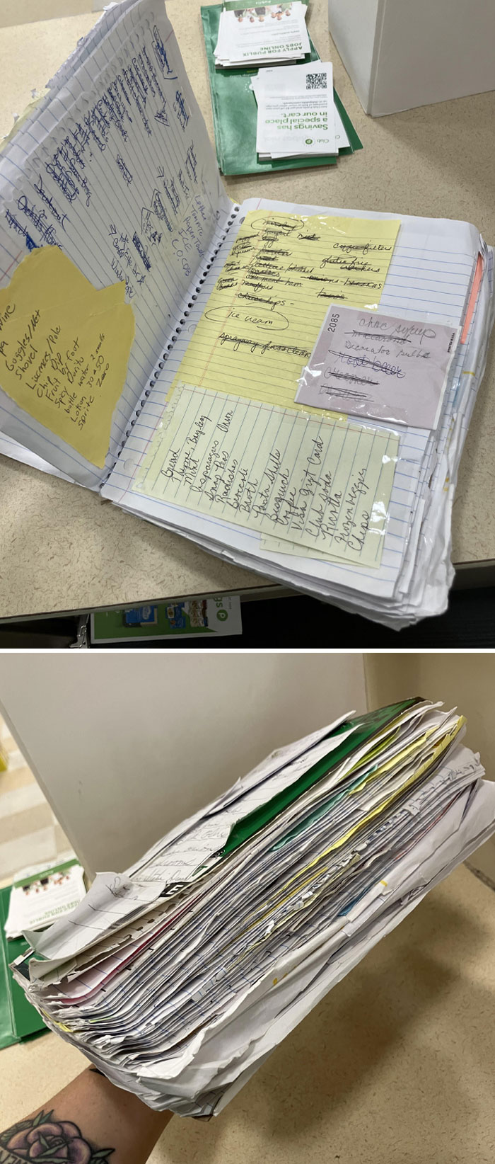 Thick homemade collection of handwritten notes and lists organized in a well-used notebook at home.