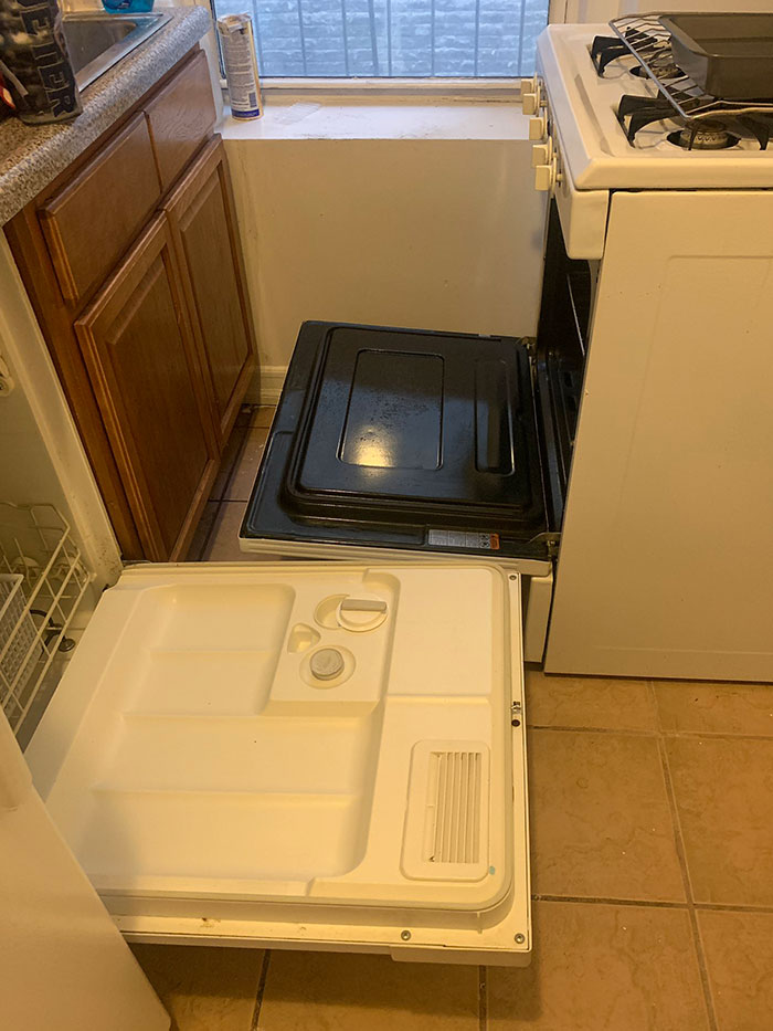 Kitchen with dishwasher and oven doors open simultaneously, showcasing dumb interior design decisions and lack of common sense.
