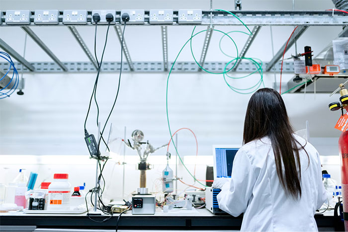 Scientist in a lab surrounded by advanced technology and equipment, exploring innovations changing humanity's future.