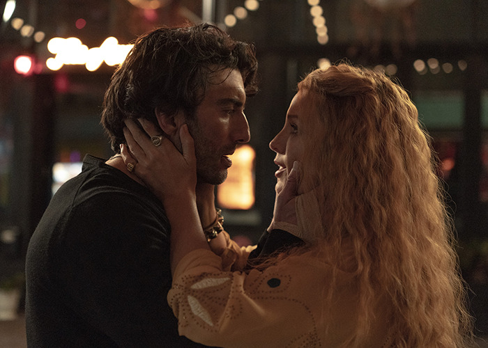 Couple sharing an intimate moment in dim light, representing Scarlett Johansson breaking silence on Ryan Reynolds and Blake Lively lawsuit.