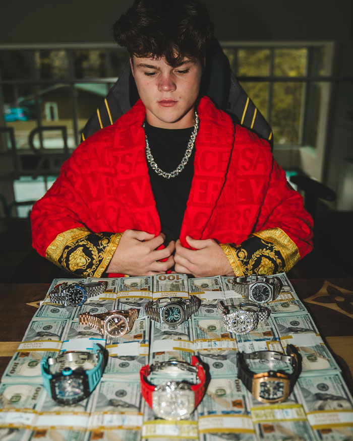 Jack Doherty showcasing luxury watches and stacks of cash, highlighting Jack Doherty net worth and rising success.