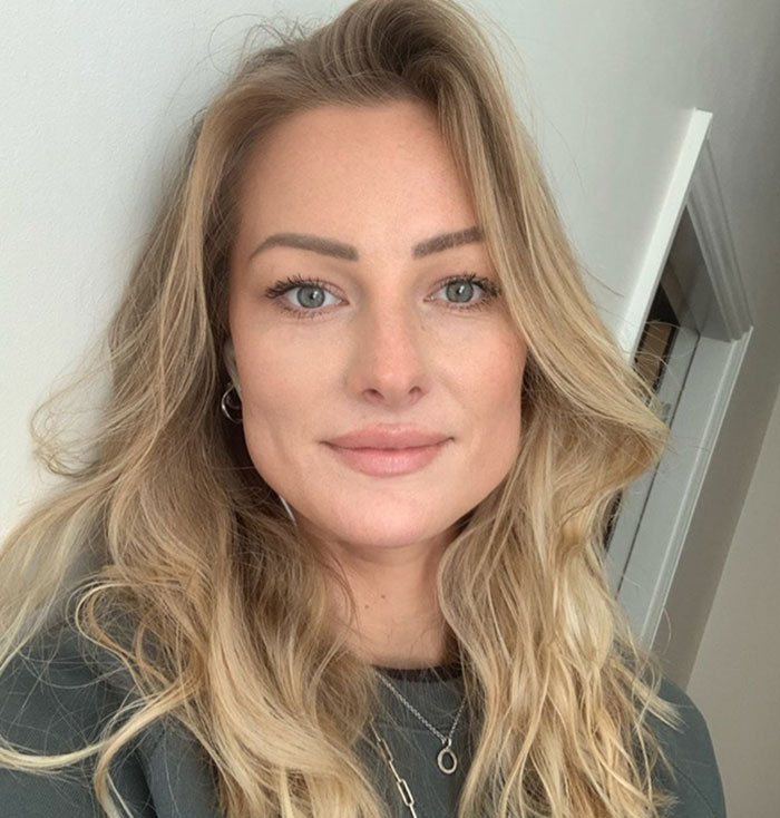 Young experienced skydiver with long blonde hair posing indoors, known for over 400 flights before her tragic demise.