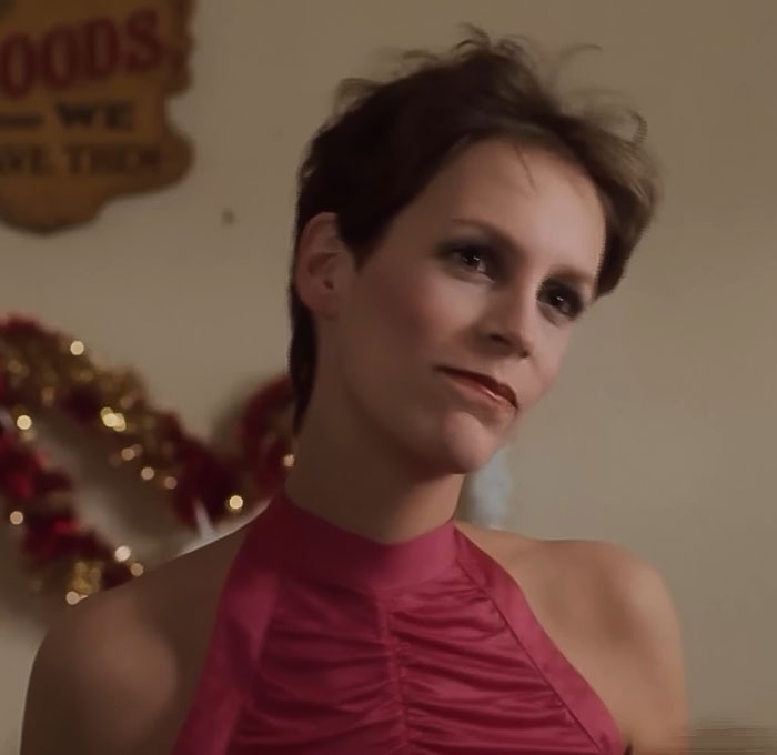 Jamie Lee Curtis in a pink top with short hair, recalling the cameraman remark that prompted her plastic surgery at 25. Jamie Lee Curtis in a pink top with short hair, recalling the cameraman remark that prompted her plastic surgery at 25.