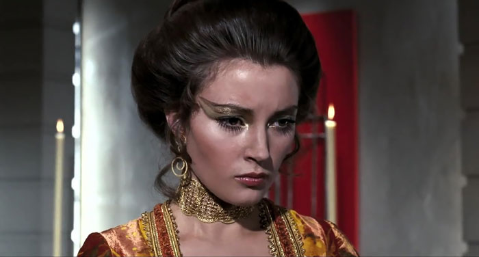 Actress Jane Seymour in an ornate costume with gold makeup, showing a youthful look that amazes fans at age 74.