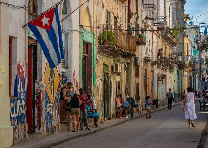 Street scene in a historic, once popular tourist destination with old buildings and people in a lively setting.