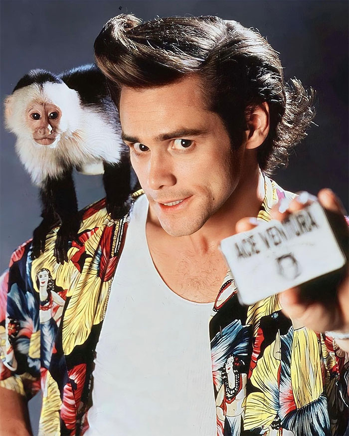 Jim Carrey smiling with a colorful shirt and a monkey on his shoulder, highlighting Jim Carrey&rsquo;s net worth and mansion drama.