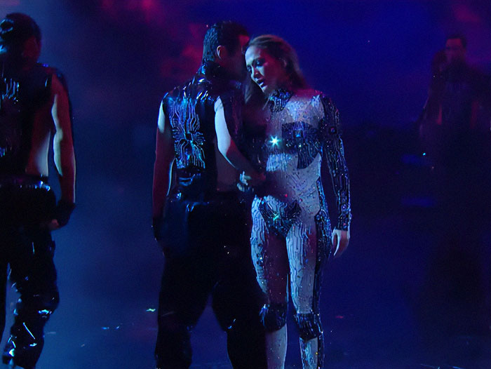 Jennifer Lopez performing a controversial lesbian kiss during the AMAs amid intense public reaction.