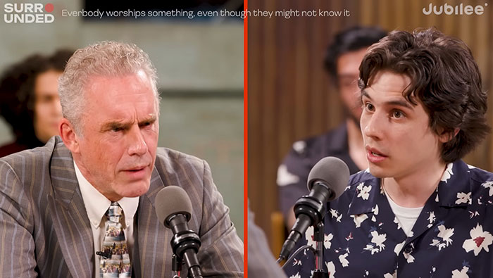 Jordan Peterson in a debate with atheists, speaking passionately during a recorded discussion event.