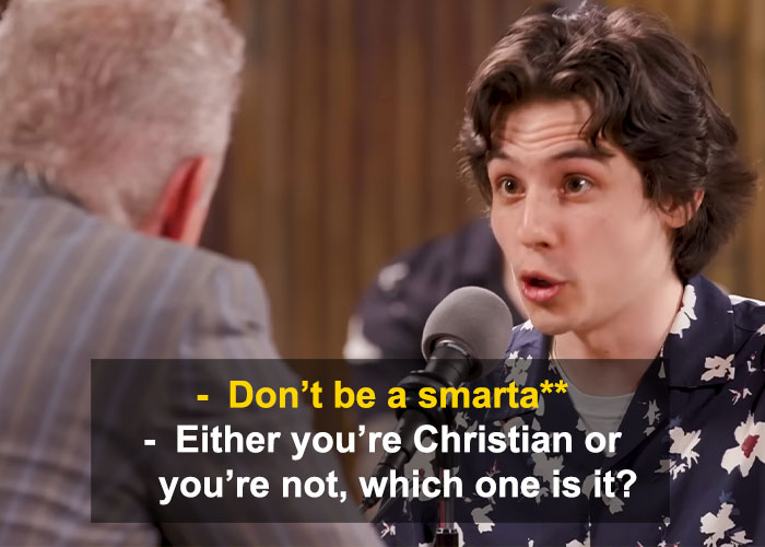 Young man speaking passionately into a microphone during a debate, highlighting Jordan Peterson brutally roasted in debate against atheists.