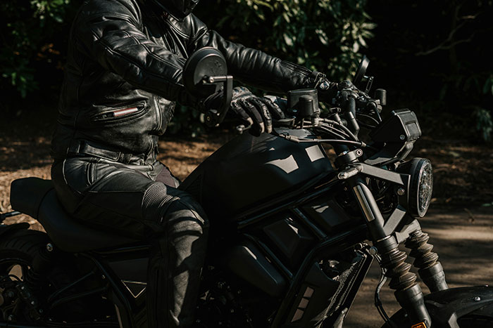 Motorcyclist wearing full protective gear as a precaution that saved their life while riding outdoors.