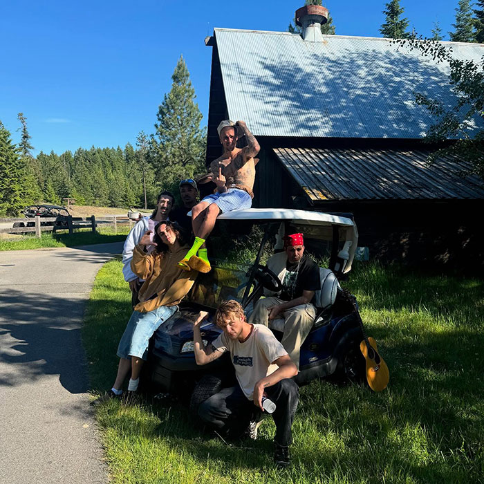 Justin Bieber and friends outside a cabin on a sunny day, sparking a fiery parenting debate over smoking.