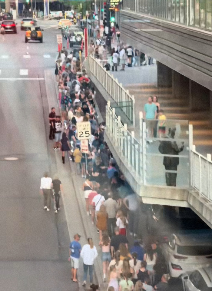 Long line of people waiting outside a venue, possibly related to Katy Perry’s world tour experiencing new setbacks. Long line of people waiting outside a venue, possibly related to Katy Perry’s world tour experiencing new setbacks.