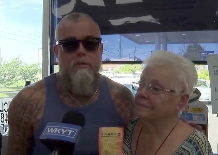 Man with sunglasses holding lottery ticket during interview after winning $167 million in lottery and getting arrested days later Man with sunglasses holding lottery ticket during interview after winning $167 million in lottery and getting arrested days later