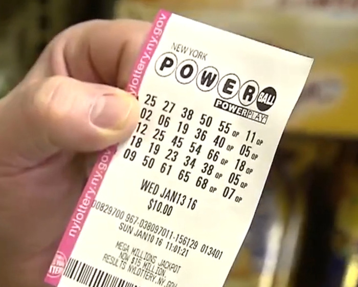 Close-up of a hand holding a New York Powerball lottery ticket related to a man winning $167 million. Close-up of a hand holding a New York Powerball lottery ticket related to a man winning $167 million.
