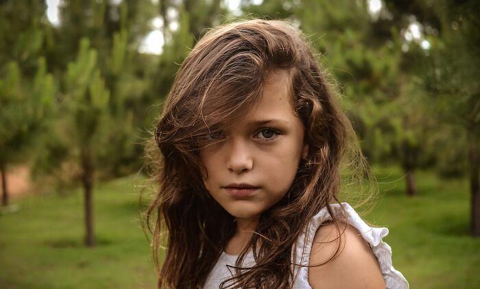 Young girl with serious expression in an outdoor setting, representing hilariously bad names that had people questioning parents.