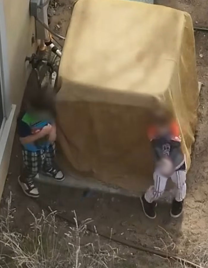 Two little boys in Minecraft and Star Wars pajamas standing outside near a covered object refusing to drop weapon. Two little boys in Minecraft and Star Wars pajamas standing outside near a covered object refusing to drop weapon.