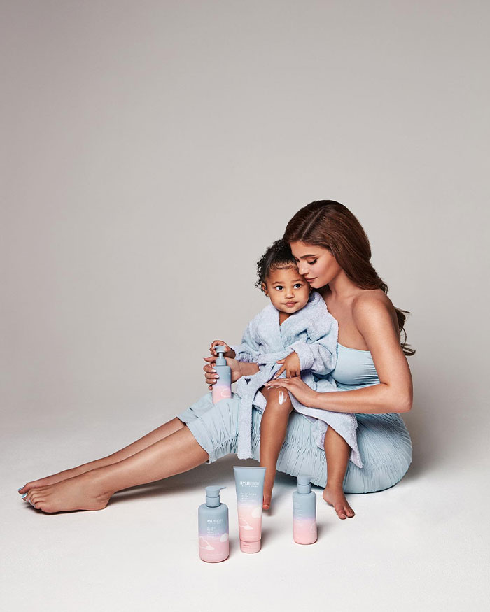 Kylie Jenner sitting with her child, applying skincare products, highlighting Kylie Jenner&rsquo;s net worth and lifestyle.