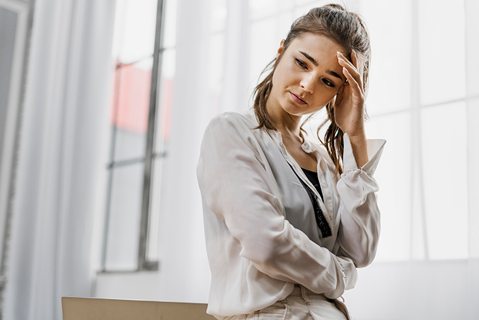 Young woman looking stressed at work, reflecting the challenges of a lazy employee facing new boss expectations. Young woman looking stressed at work, reflecting the challenges of a lazy employee facing new boss expectations.